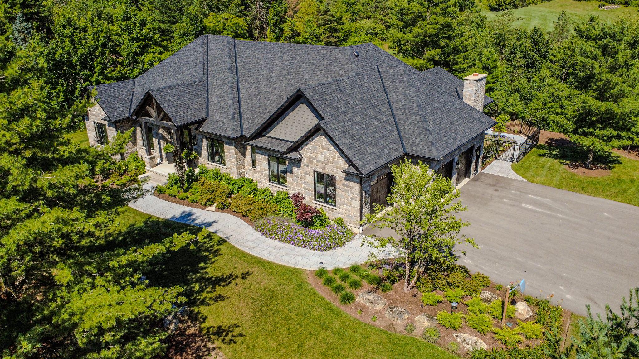 An aerial view of a home surrounded by trees for sustainable residential landscaping design