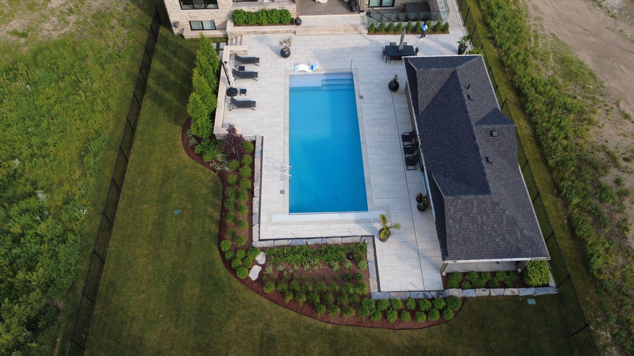 An aerial of a pool and surrounding landscape.