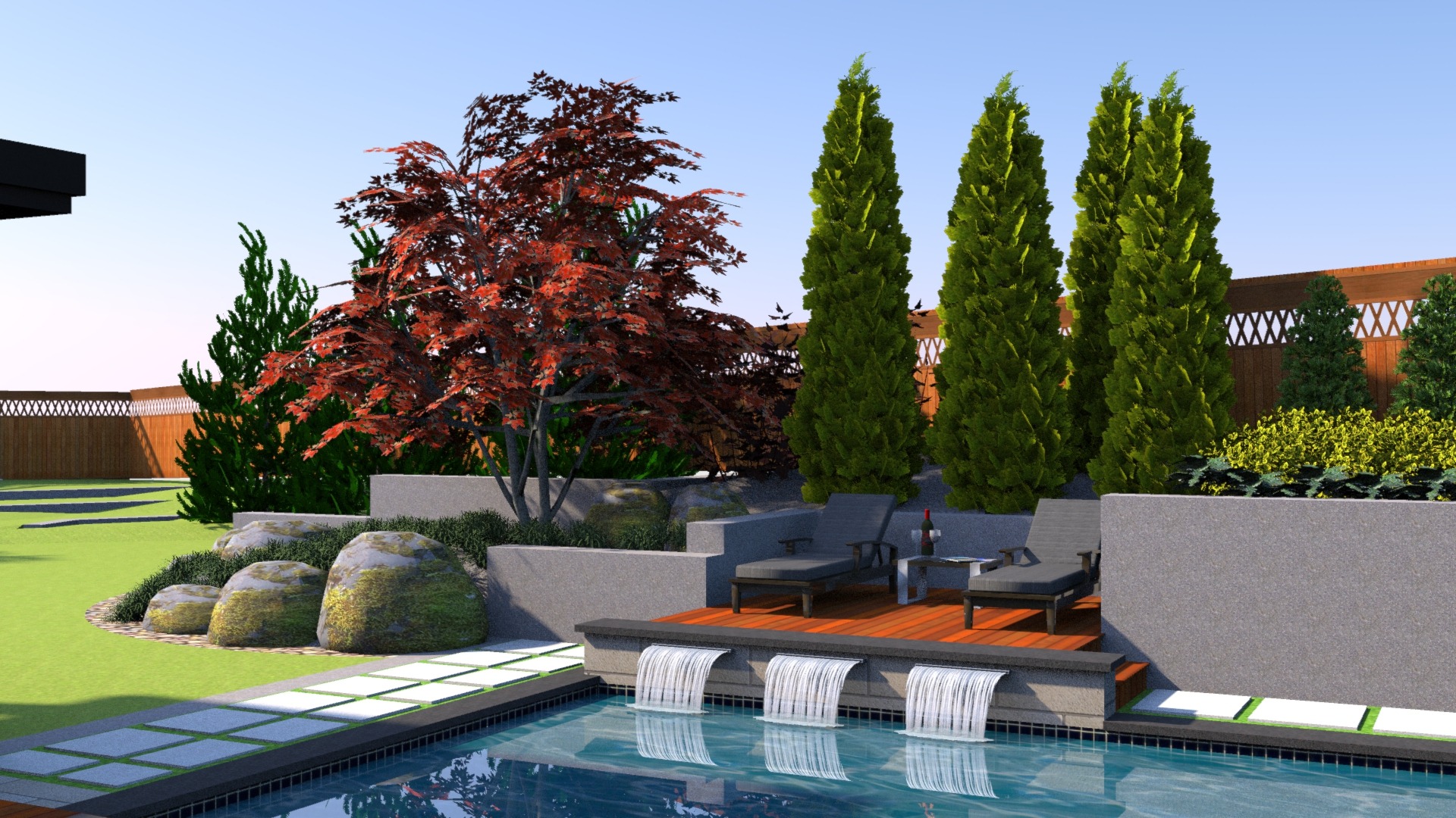 Modern backyard features a pool with three waterfalls, wooden deck with chairs, red and green trees, bushes, and neatly arranged rocks.
