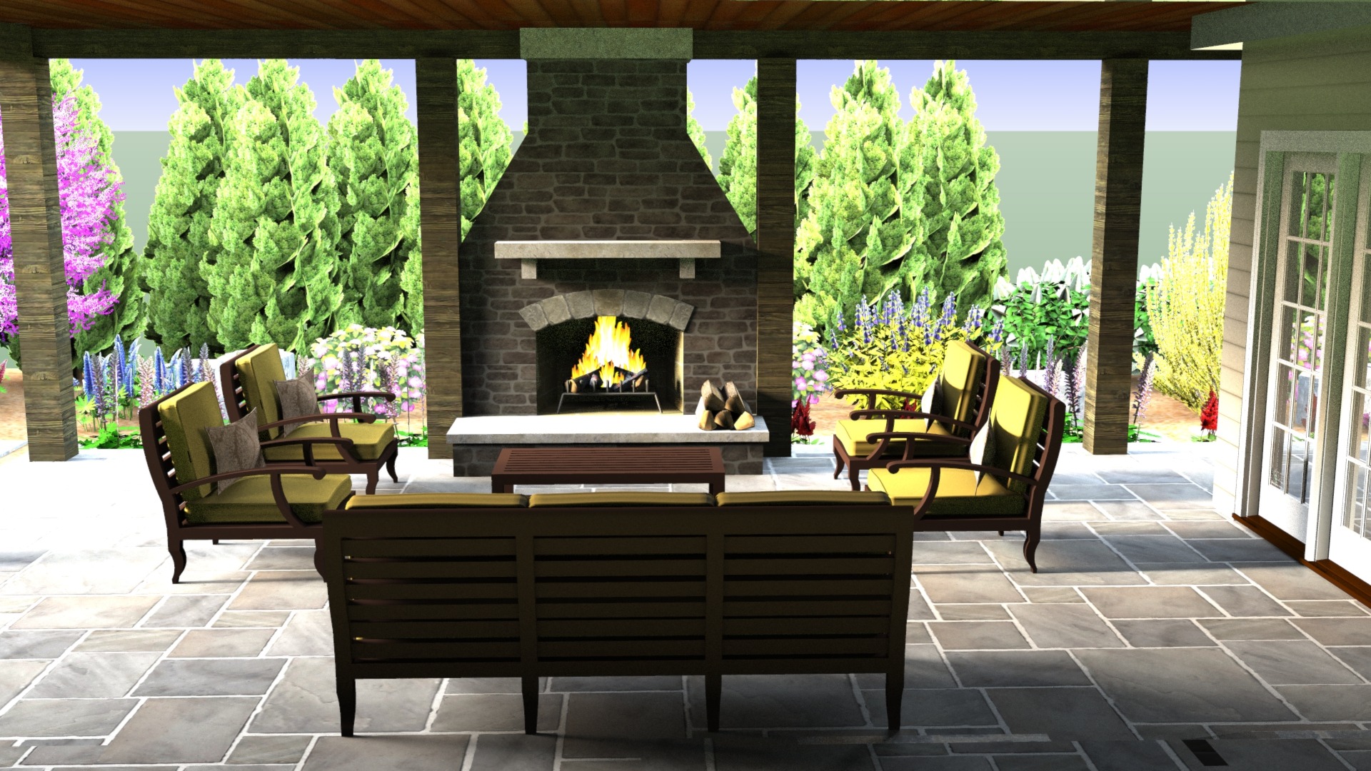 A cozy outdoor patio features a stone fireplace, surrounded by cushioned seating and lush garden views with tall greenery and colorful flowers.