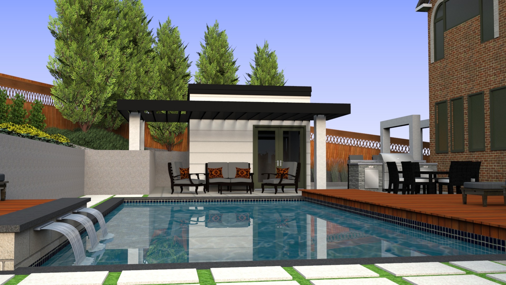 A modern backyard features a pool, waterfall, seating area, and outdoor kitchen with lush trees and a brick building nearby.