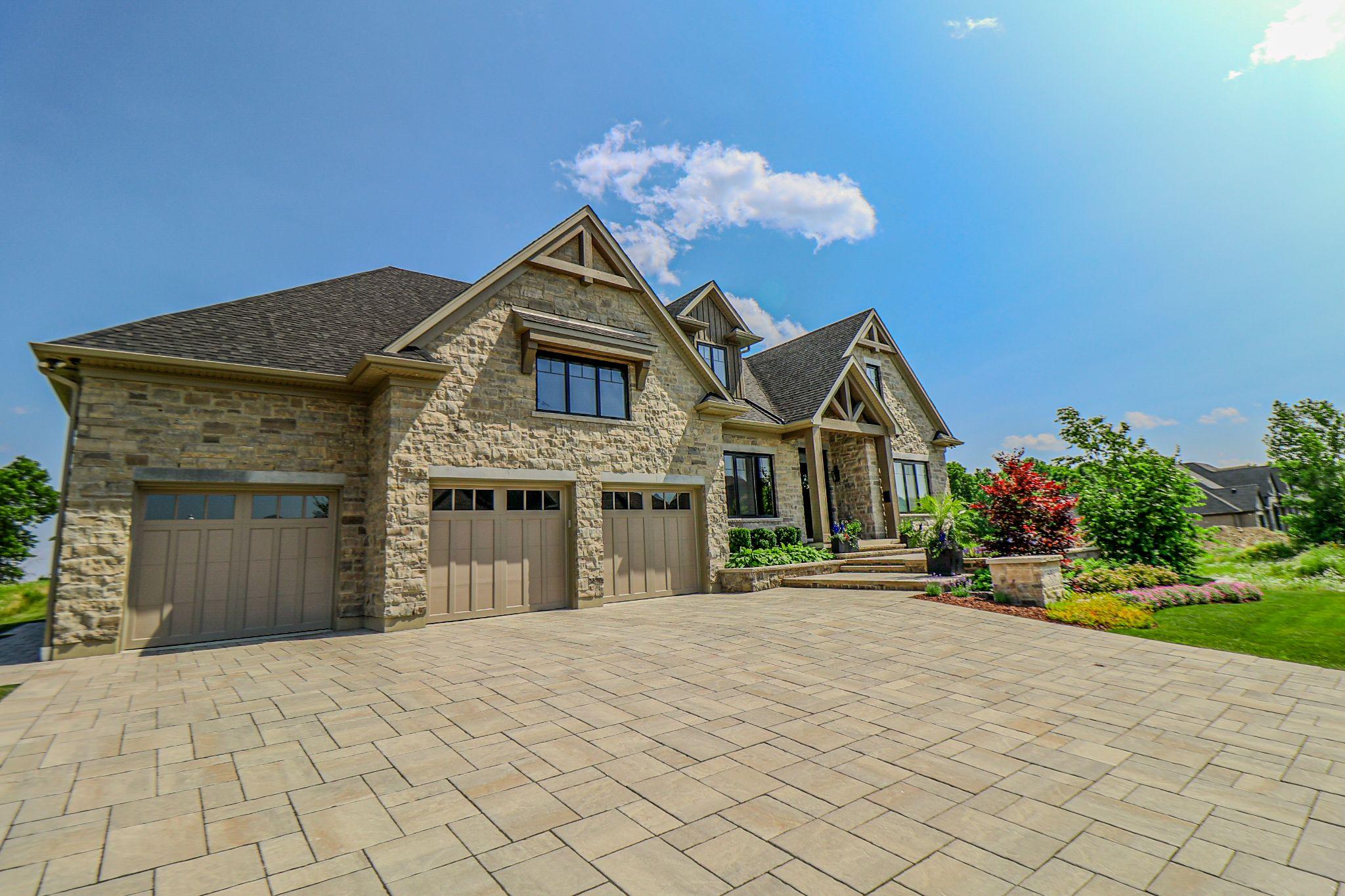 A house with an interlock driveway as part of its residential landscaping.