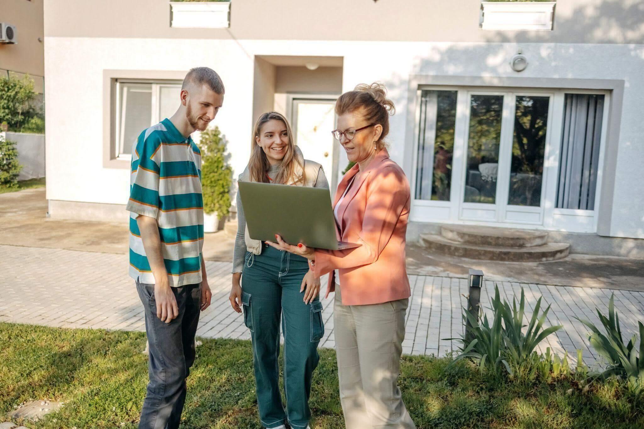 People standing in front of a modern house.