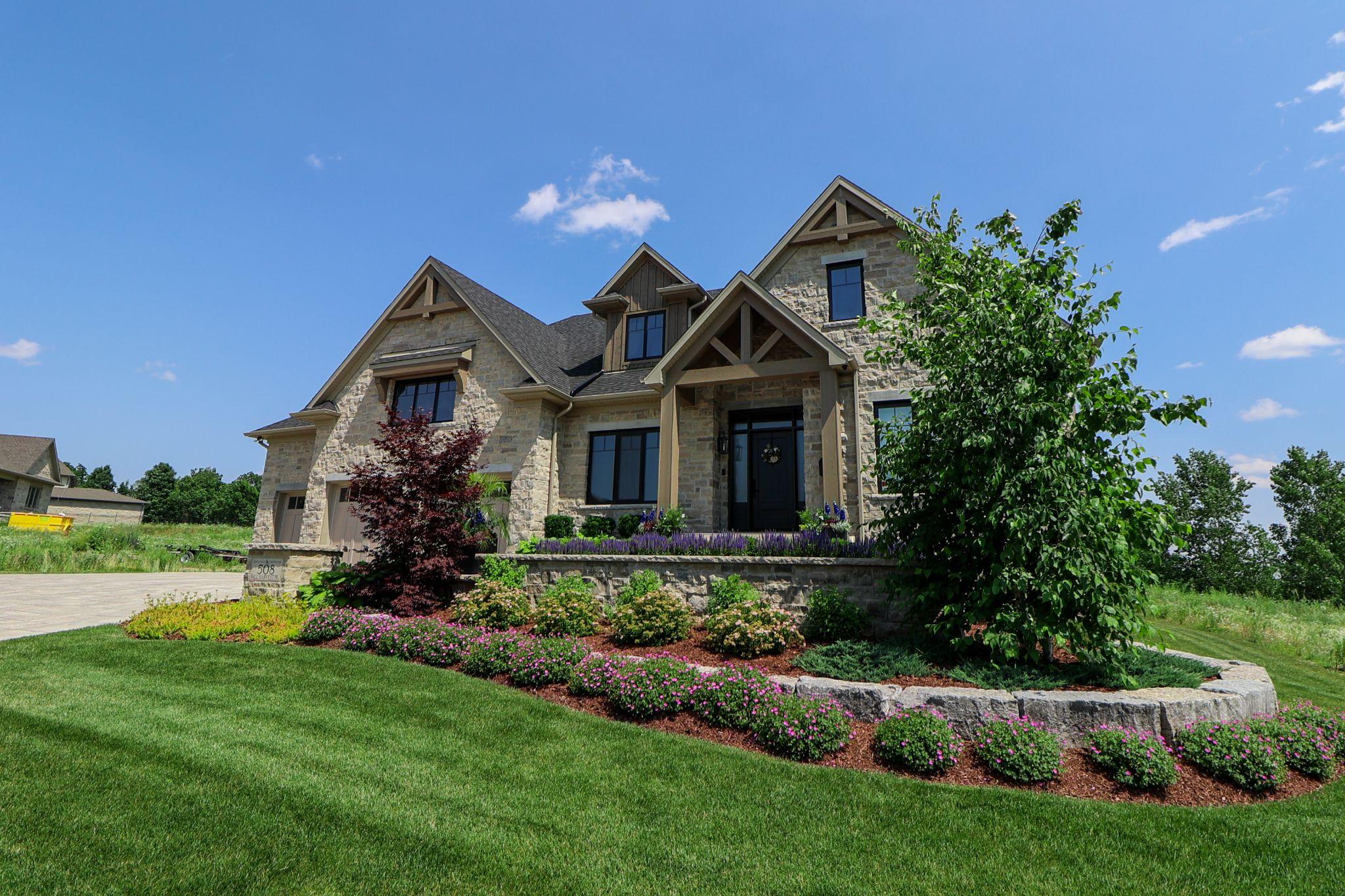A house with flower beds showcasing backyard landscaping ideas.